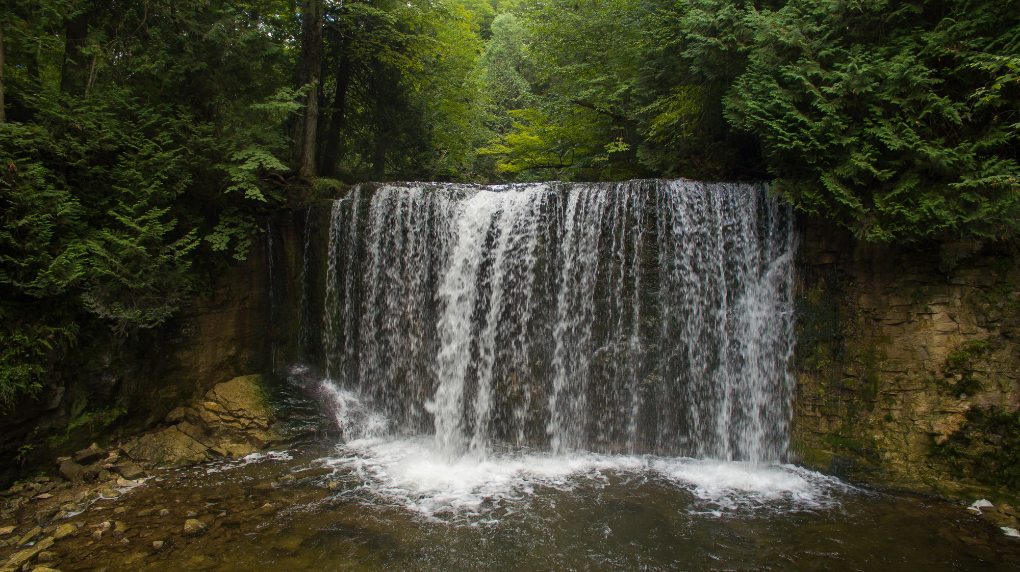 Holstein Dam Falls wide curtain waterfall in Jubilee Park Grey County Ontario