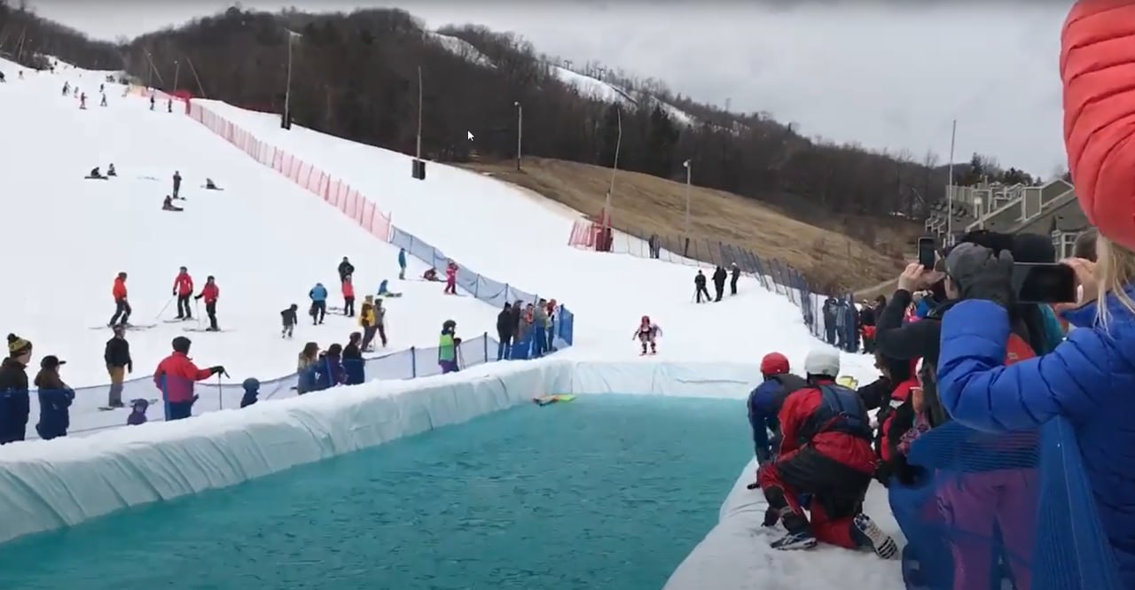 Retro Pond Skim event at Blue Mountain with skiers and snowboarders crossing a pond
