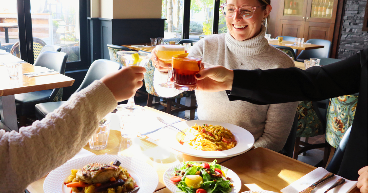 Friends toasting at SpringLicious dining event Blue Mountain Village