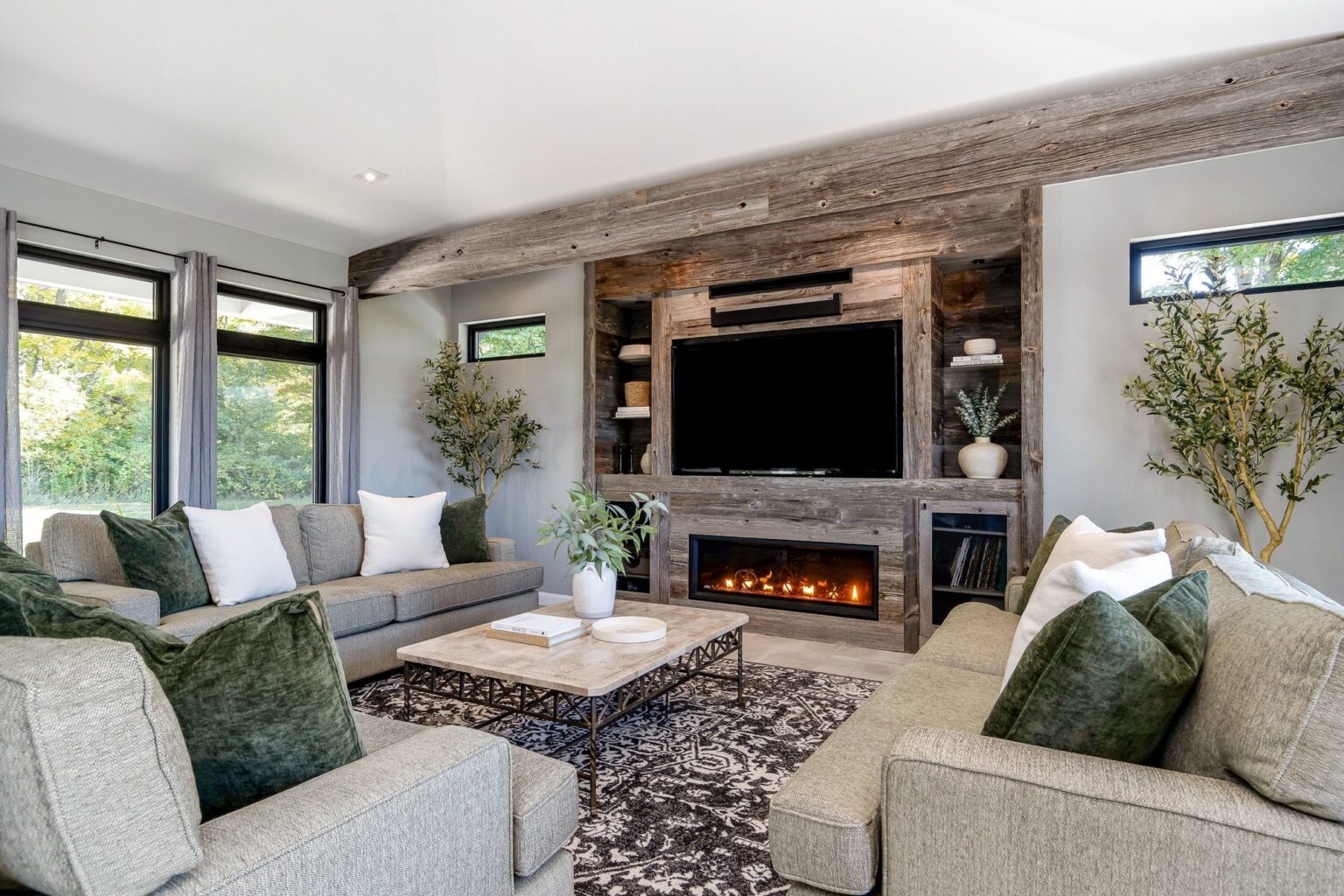 Living room seating around the barnboard fireplace wall