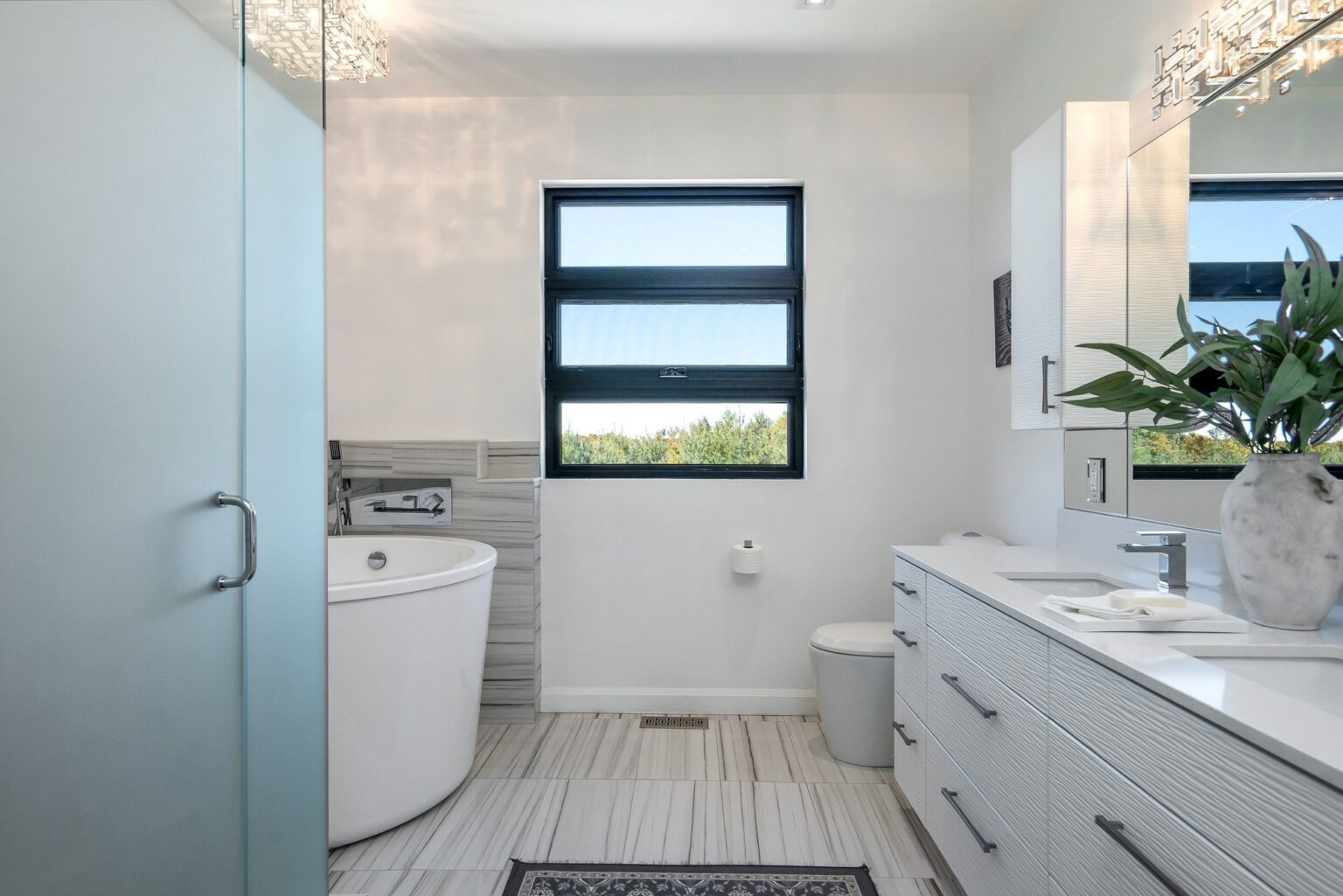 Five-piece primary ensuite with double vanity and freestanding tub